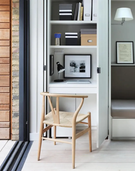 <p>A vertical nook used as a home office set-up in a small living space</p>