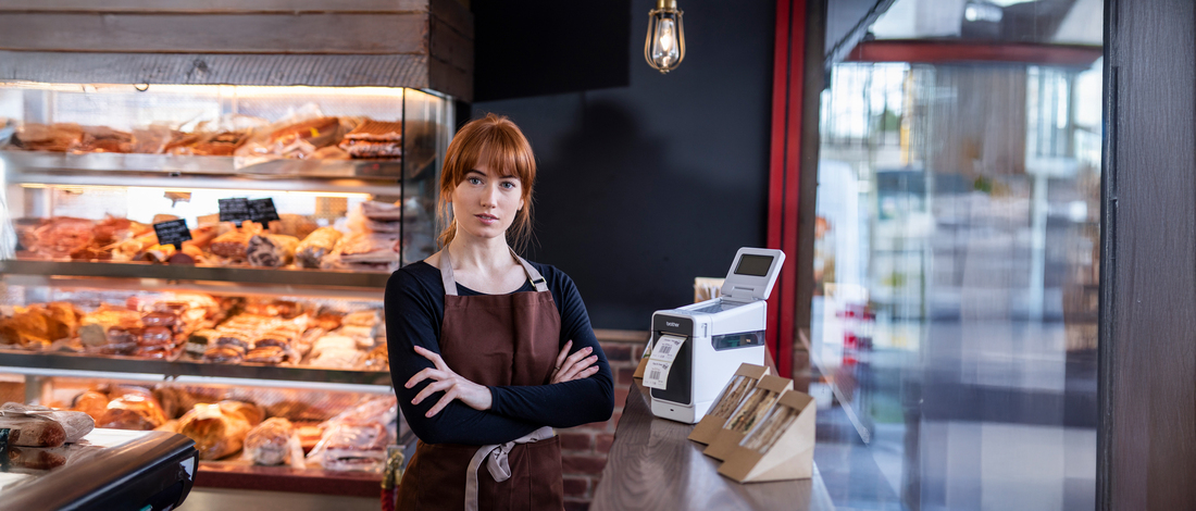 <p>A woman within Retail environment with the TD2000 label printer. </p>
