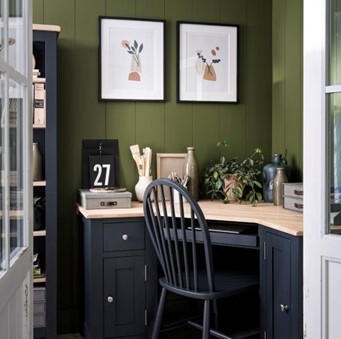 <p>A British-style box room set up with a small home office desk and chair</p>