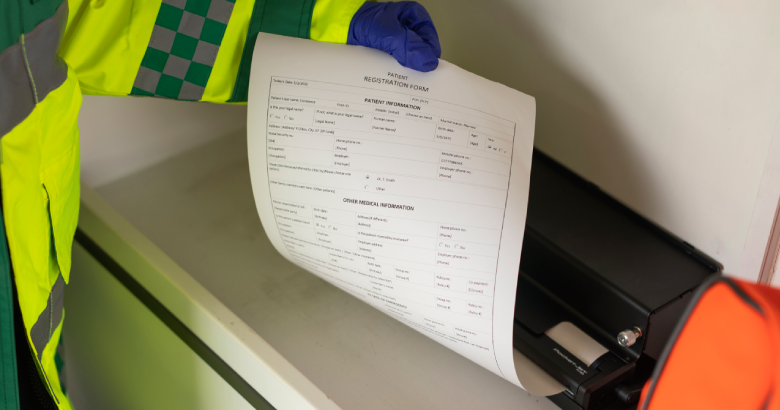 <p>An image of a healthcare worker printing patient documents in situ </p>
