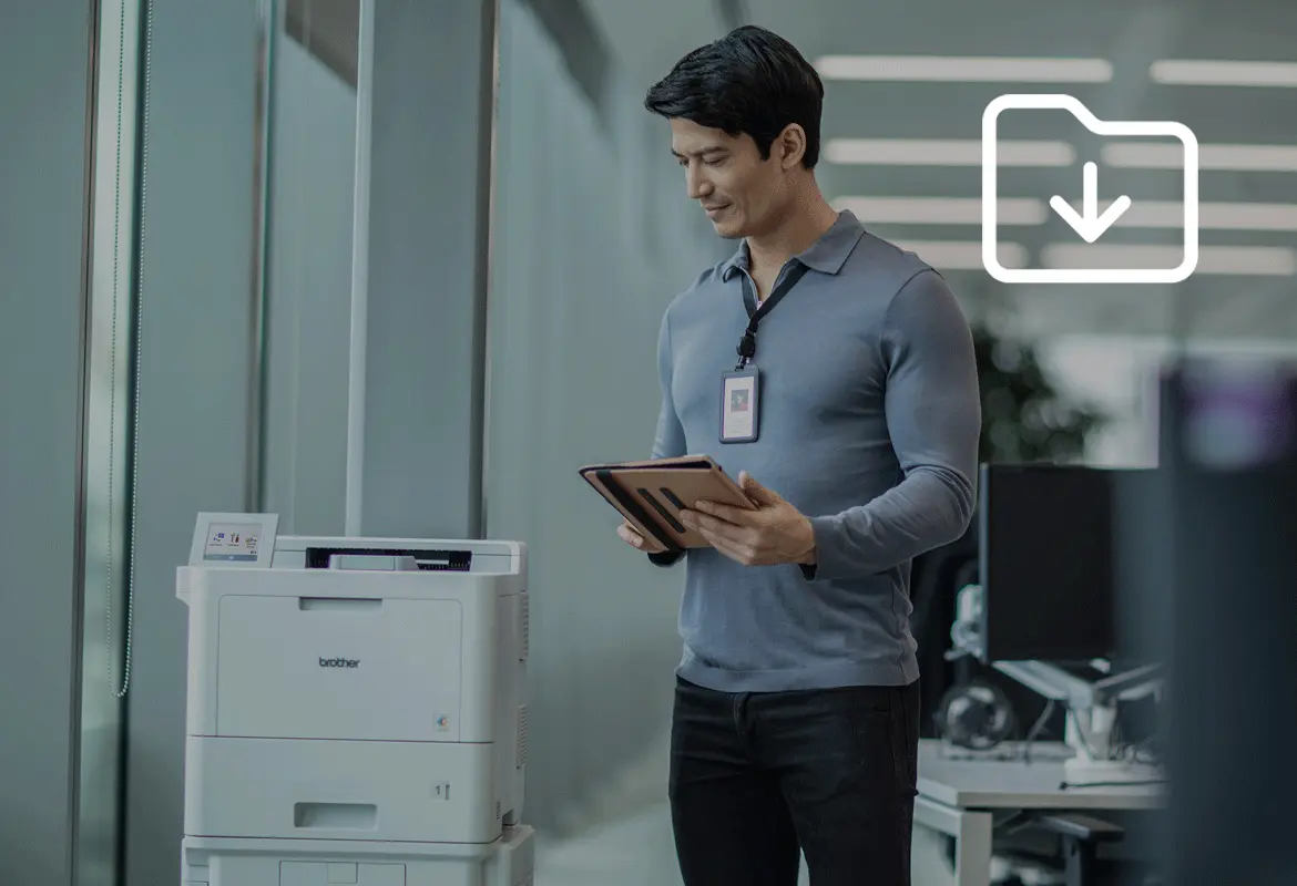 <p>A person using Brother printer in an office environment, an icon in the top right corner of the image representing a download action</p>
