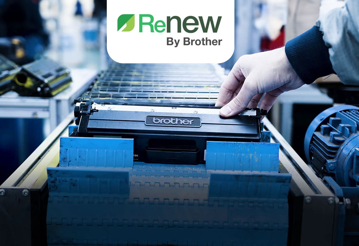 Production line of black Brother toner cartridges with a hand holding the one at the front with the Renew logo above in green
