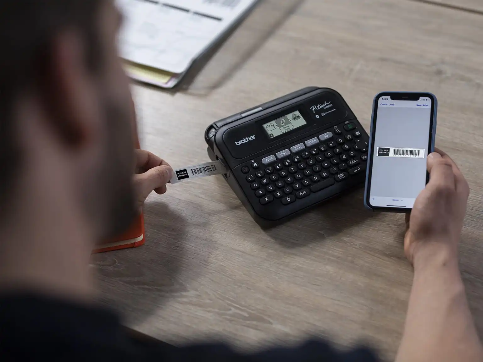 man editing a label on the brother iprint&label app